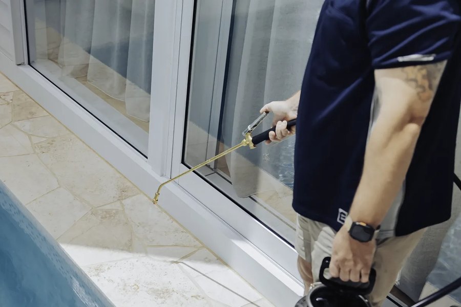 Applying GlassProtect to a sliding glass door with a pressure sprayer