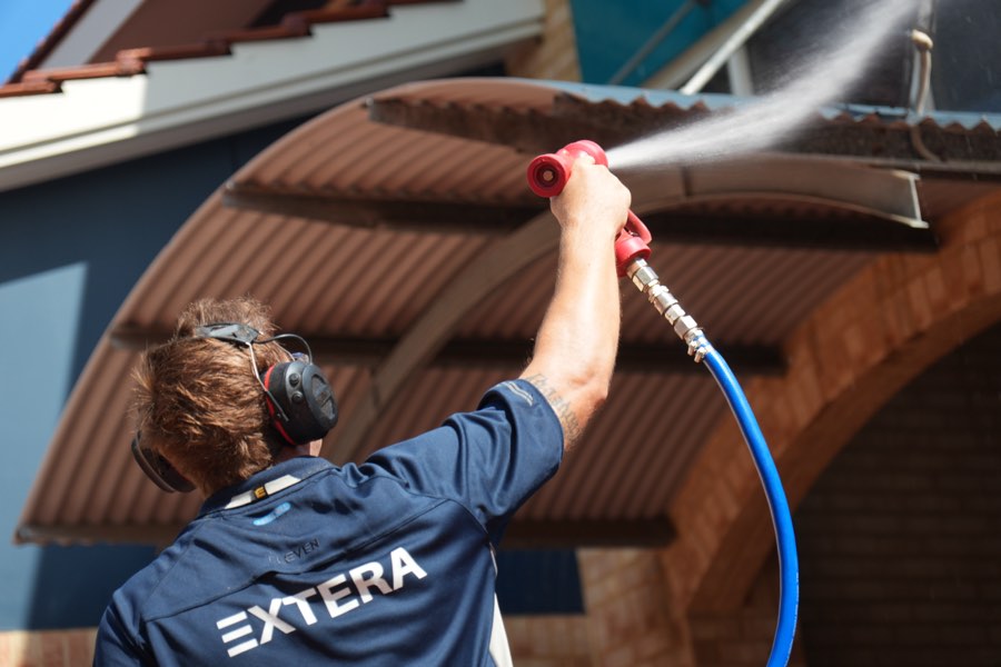 Soft washing a rendered wall and eaves at height