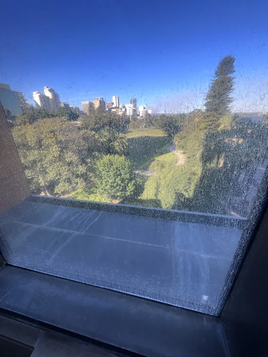 Corroded high-rise window glass before restoration