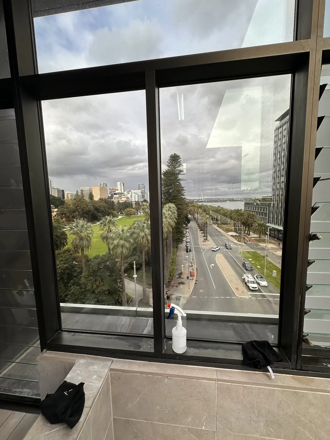 Restored window glass, clear again with the park, road and city sharp through it