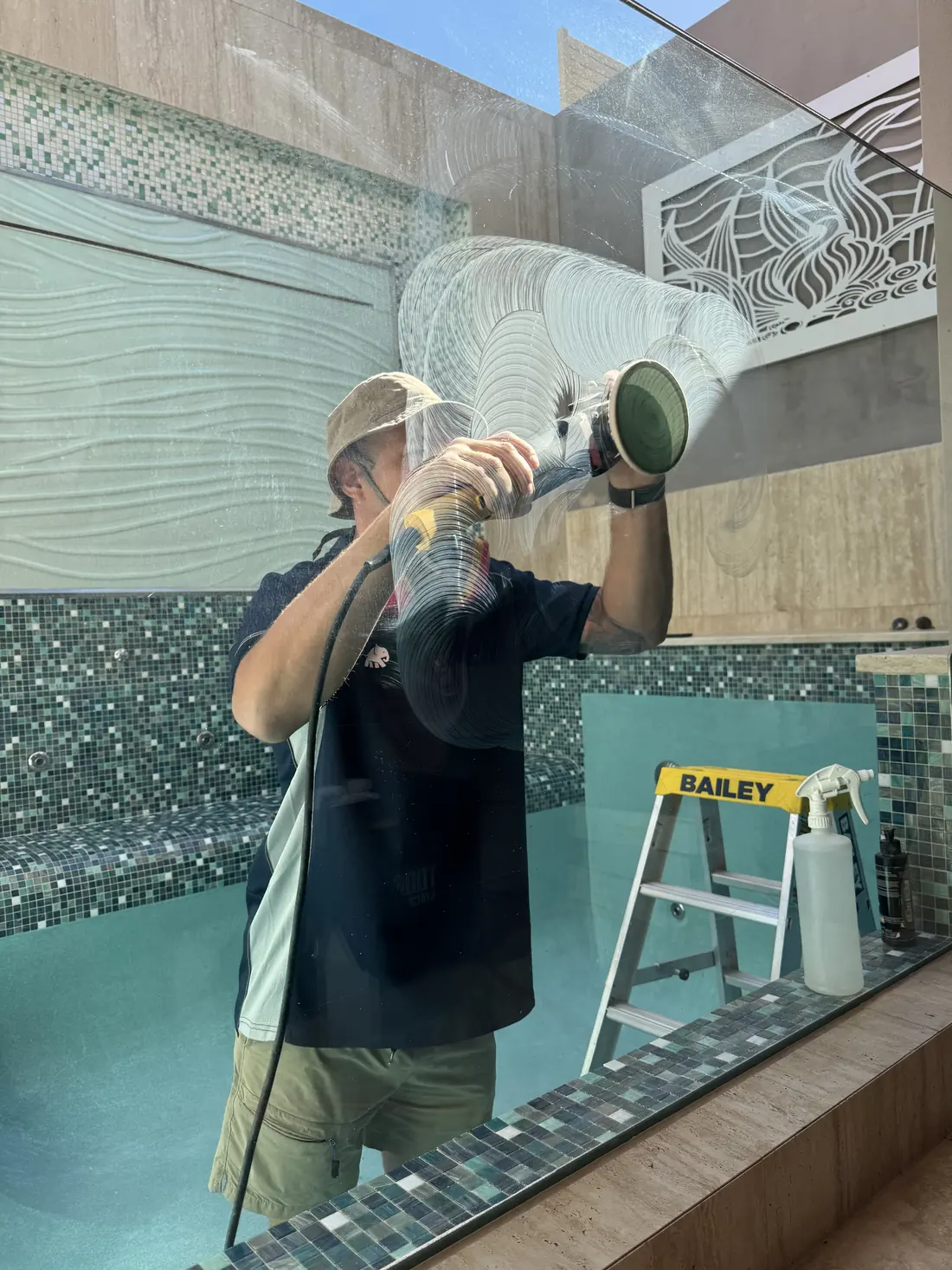Scratch removal in progress on a glass panel